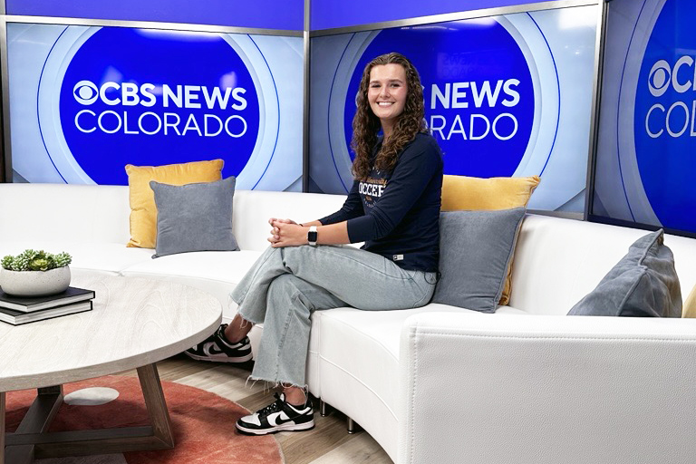 Madison smiles for the camera while sitting on the set of CBS News Colorado